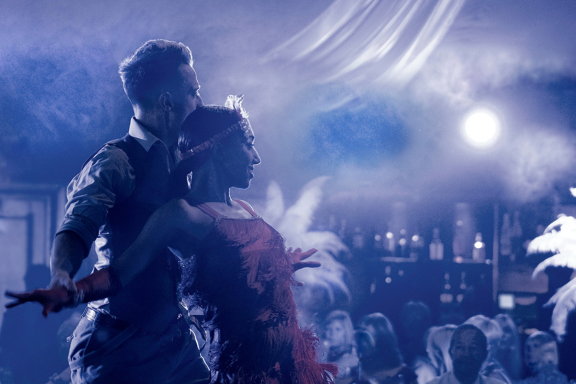 Two dancers embrace within smoke during private event in Edinburgh function room The Stables, in the grounds of Prestonfield House Hotel