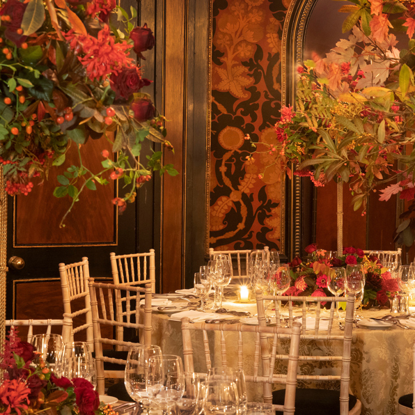 Candlelit dining tables with fine glassware, cream linen and floral centrepieces inside Rhubarb restaurant at Prestonfield Hotel Edinburgh, ideal for  large group dining and private celebrations