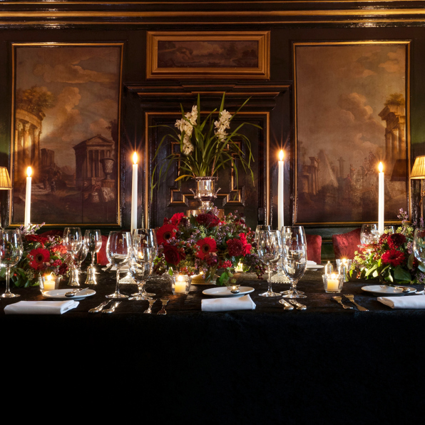 The stunning Italian Room at Prestonfield House, Edinburgh, dressed with opulent candles, glassware and red flowers